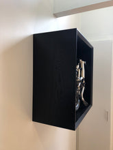 Load image into Gallery viewer, Side view of Brompton Bicycle Storage highlighting the hardwood grain finished in black satin, as well as the flush wall mounting. 