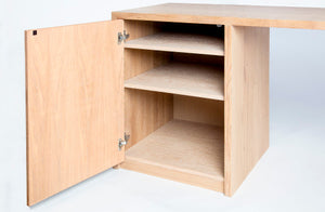 image of the storage area with the door open for the cascade reserve desk. Shows three storage shevles, also finished in cerused white oak like the rest of the office desk. Shows the Blum mounting hardware that allows the desk door to open and soft close. 