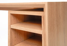 Load image into Gallery viewer, close up view of the white oak wood grain in the open storage section of the custom designed white oak desk named the cascade desk. shows brass accents for modular shelf storage. 