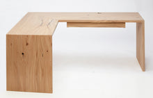 Load image into Gallery viewer, Left side view of the minimalist cascade desk. Shows in full view the left miter that connects the desktop to the left leg. The floating desk drawer can be seen in the image. The finish is white washed elm.